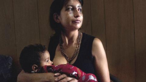 Juana, migrant, with her son in arms