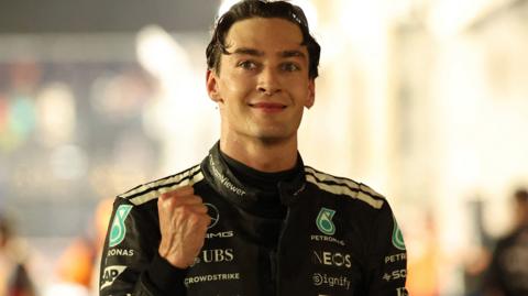 George Russell clenches his right fist in celebration after winning the Singapore Grand Prix