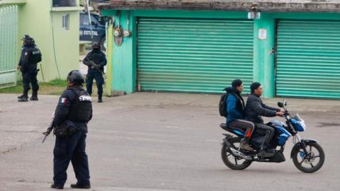 Members of the State Police stand guard in the Texcapilla sector, in the town of Texcaltitlan, in the central State of Mexico, Mexico, 11 December 2023.