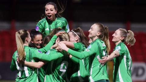 Northern Ireland players celebrate after scoring a goal