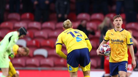 Derby's Ben Osborn hold the ball as his side reels from being scored against