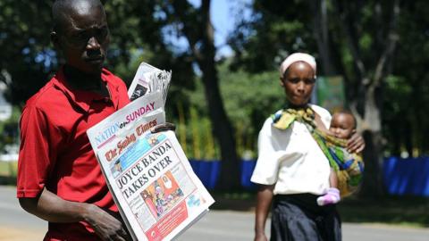 Street vendor sells newspaper on April 8, 2012 in Lilongwe with headline that Malawi's new President Joyce Banda is sworn in