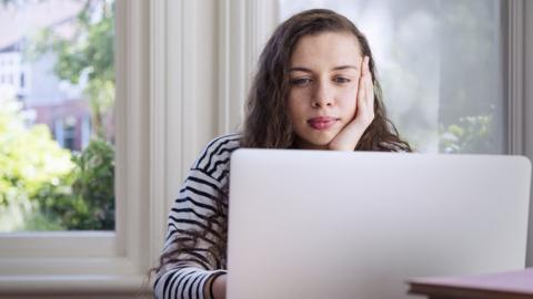 Woman looking at laptop screen