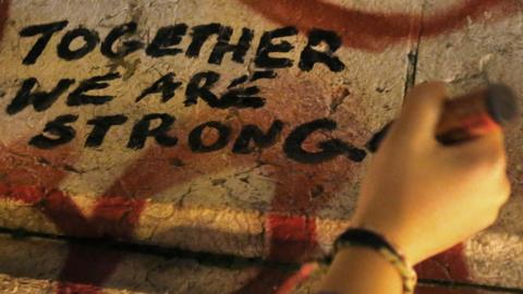 Together We Are Strong is written on a statue the day after the Paris terror attacks