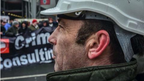 A Blacklist campaigner wearing a hardhat declaring he had been "blacklisted"
