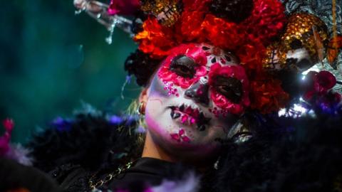 A person dressed in a costume participates in the catrinas procession as part of the celebrations for the Day of the Dead, in Mexico City, Mexico, 22 October 2023.