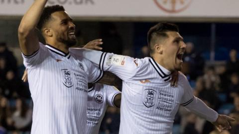 Joel Piroe celebrates with Cyrus Christie