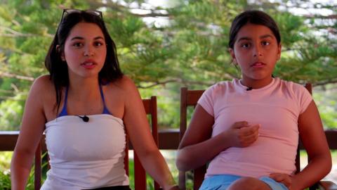 Two Tunisian children sit down on chairs and talk to the camera