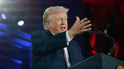 Donald Trump at a podium.