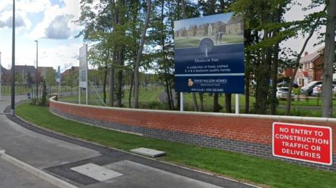 General view of Drakelow Park housing estate with boards advertising the estate to passing drivers