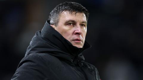 Hull City boss Sergej Jakirovic watches on from the sidelines in a black coat