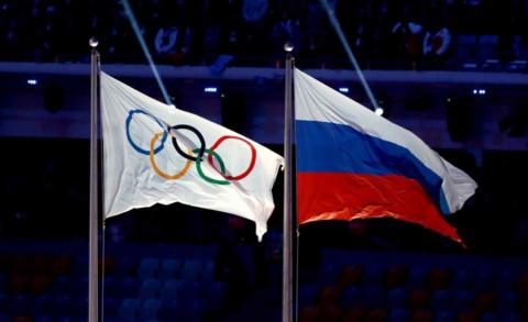 2014 file photo of Olympics flag and Russia flag