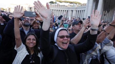 Nun looking happy with hands in the air