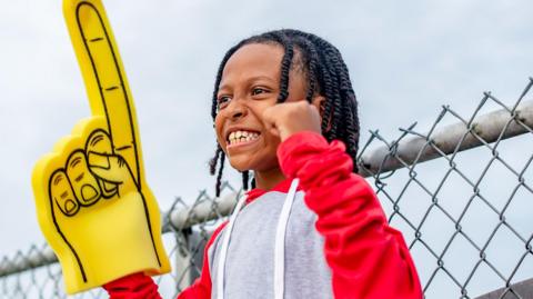 Young sports fan with foam finger. 