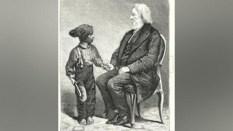 A drawing of a man with grey hair and a grey beard wearing a dark suit and sat on a chair holding the hand of a chimney sweep boy who is wearing dark trousers and a shirt and is dirty from soot and holding a brush.