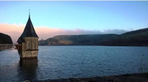 Pontsticill reservoir at sunset with a red and blue sky 