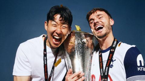 tSon Heung-min and James Maddison of Tottenham Hotspur pose for a photo with the Uefa Europa League trophy