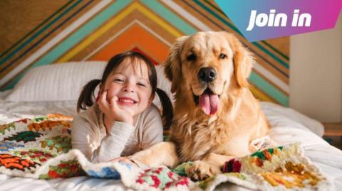  Girl lying on a bed with her golden retriever dog.