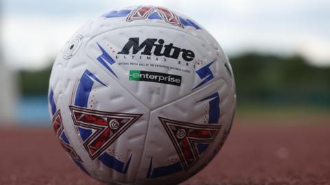 A National League football on an athletics track