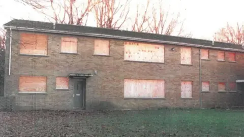 A boarded up former care home.
