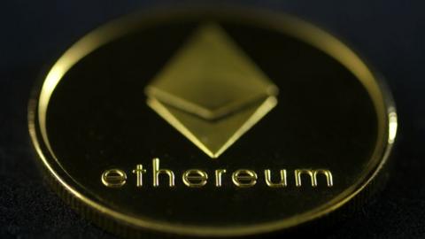 An Etherium "coin" featuring the name and diamond-shaped logo of the currency