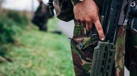 Close up of a solider holding a gun