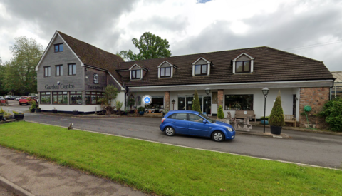 The Old Well Garden Centre - a big brown and white building. 