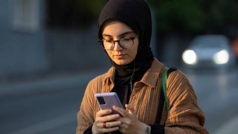 Muslim lady on a phone