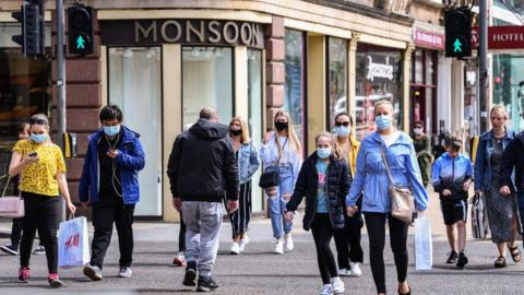 Members of the public wear face covering as they shop on Princess Street on July 10, 2020 in Edinburgh, Scotland.