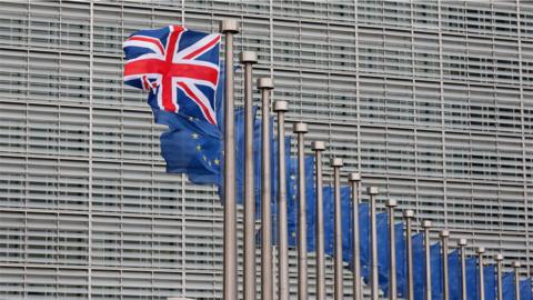 The union flag flying next to a row of EU flags