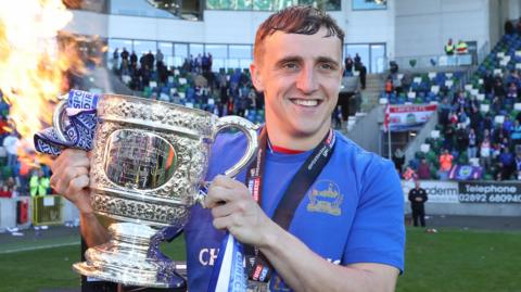 Joel Cooper celebrates with the Gibson Cup