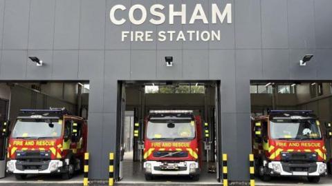 The front of the new Cosham Fire Station. Three fire engines stand in their bays, ready to depart. The station sign is overhead.