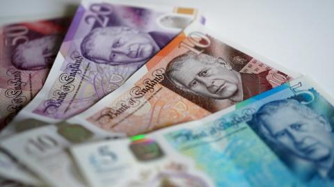 A shot of bank notes laid flat on a surface.