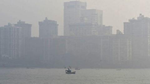 A view of the cityscape engulfed in smog amid hazy weather, at Girgaon Chowpatty, on December 6, 2022 in Mumbai, India.