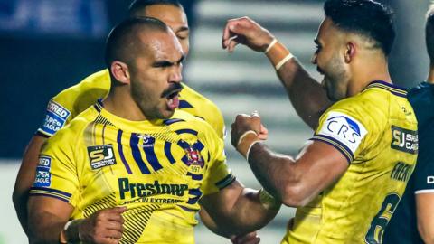 Wigan's Tommy Leuluai celebrates his try with Bevan French and team-mates