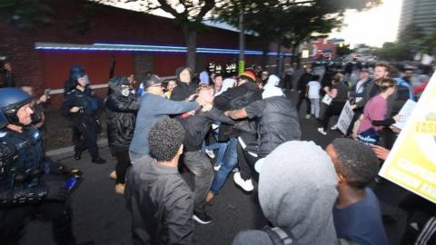 Protesters clash on a street outside the event in Melbourne