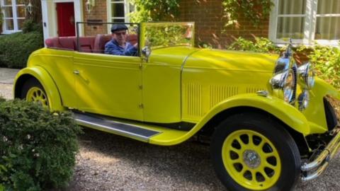 Malcolm Stern in his father's yellow 1930's classic car