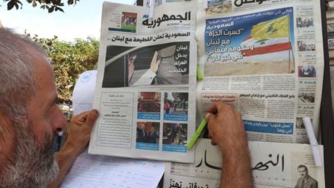 A newspaper vendor arranges newspapers at his stall in the Lebanese capital Beirut