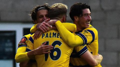 Torquay United players celebrate a goal