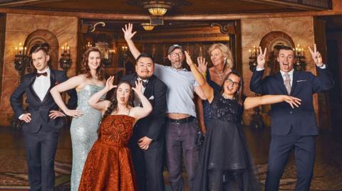 The cast of Better Date Than Never in formal dress, with the shows creator and director, Cian O'Clery
