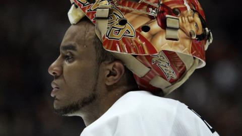 Ottawa Senators goaltender Ray Emery takes a break in between periods with his graphic helmet