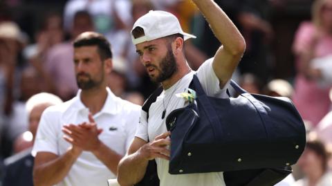 Jacob Fearnley is clapped off Centre Court by Novak Djokovic 