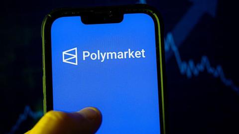 In this photo illustration, a Polymarket logo is seen displayed on a smartphone. 