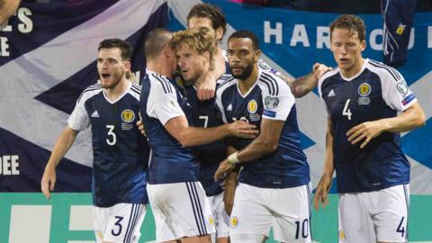 Stuart Armstrong celebrates with his team-mates after he heads Scotland in front