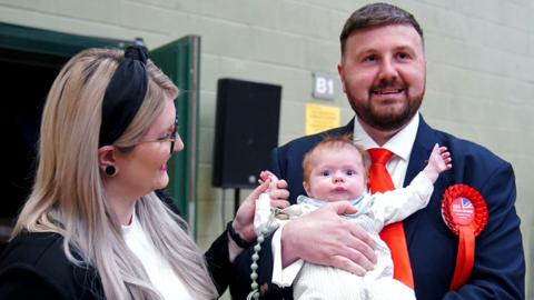 Labour candidate Chris Webb celebrates with his wife Portia and baby Cillian Douglas Webb after winning the Blackpool South by-election following the count at Blackpool Sports Centre, Blackpool, on 3 May 2024