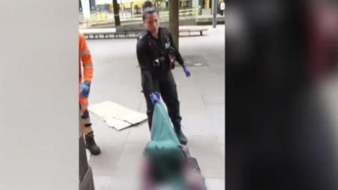 The police officer dragging the man