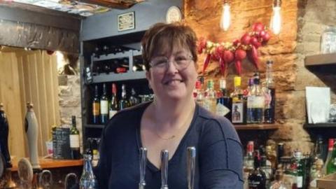 Lisa Pandy behind the bar