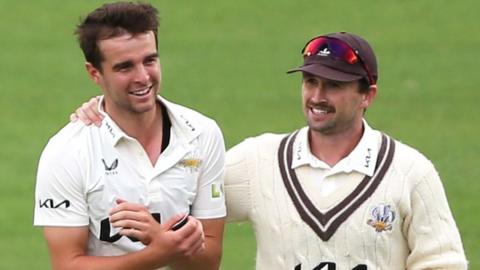 Surrey bowler Tom Lawes (left) celebrates with Dan Worrall after taking the wicket of Northamptonshire batsman Rob Keogh