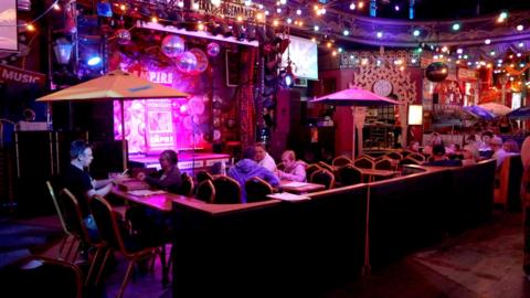 brightly coloured interior of the Empire in Great Yarmouth showing sofas and tables and bar paraphenalia