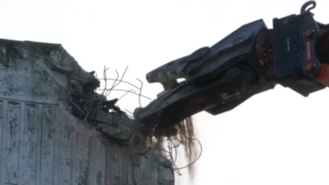 A multi-storey car park is the first major building to be cleared, with hydraulic crushing machines.